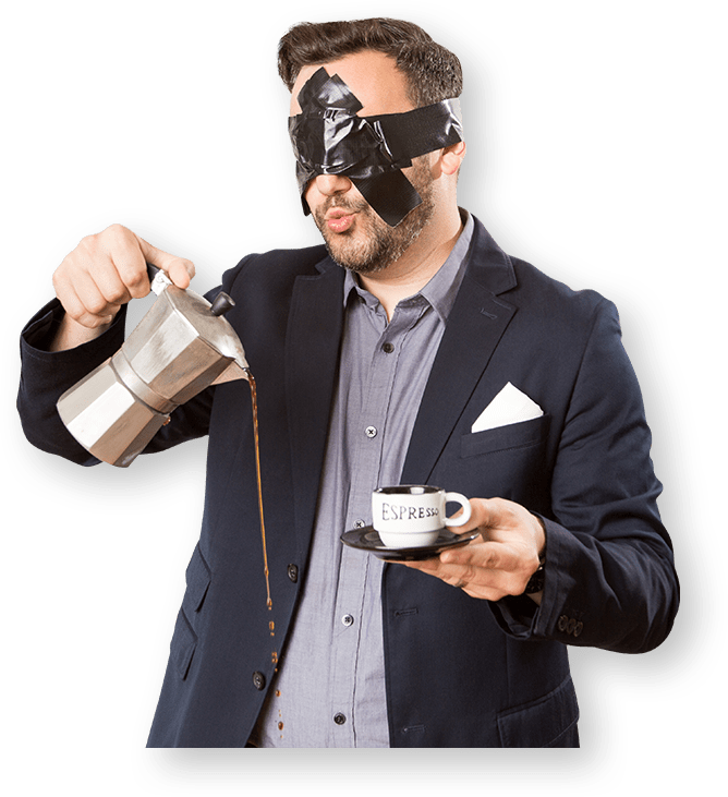 A man with a blindfold holding a cup of coffee.