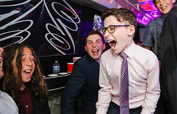 A group of people laughing and enjoying themselves on a party bus.