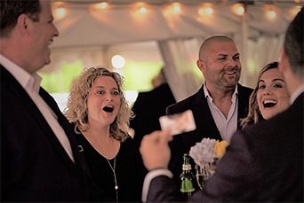 A group of people laughing at a party.